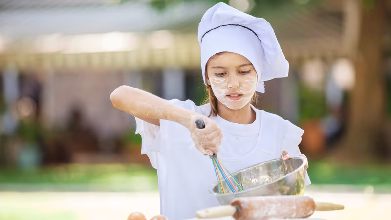Child helping in the kitchen — getting kids involved with Ninja Creami recipes