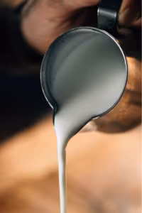 Fresh milk being poured — choosing the right dairy is key to creamy Ninja Creami results